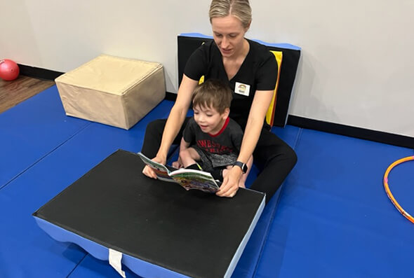 Child being read a book during therapy